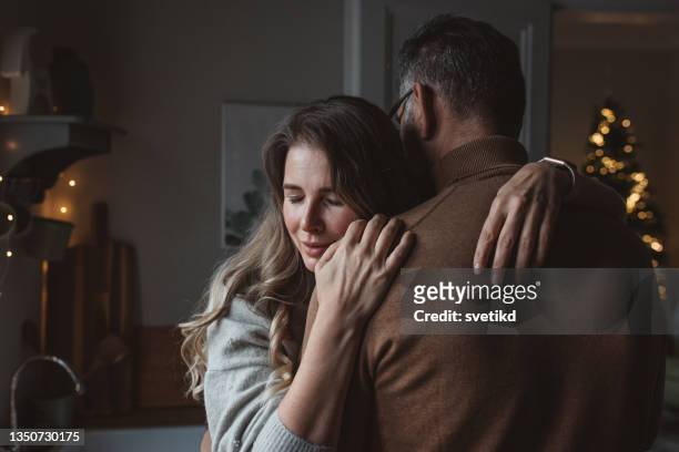 mature couple for christmas at home - couple sadness stock pictures, royalty-free photos & images