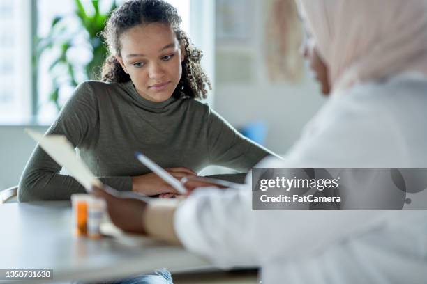 patient discussing medication - teen and doctor stock pictures, royalty-free photos & images
