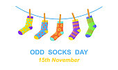 Odd socks day. Anti bullying week banner. Different colorful odd socks hanging on the rope. Vector cartoon illustration
