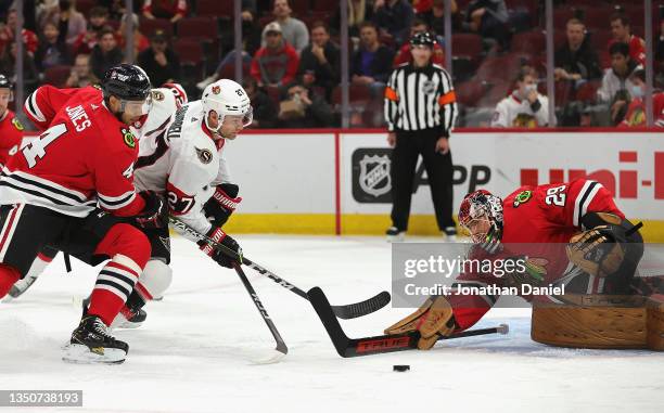 Marc-Andre Fleury of the Chicago Blackhawks makes a save against Dylan Gambrell of the Ottawa Senators as Seth Jones defends at United Center on...