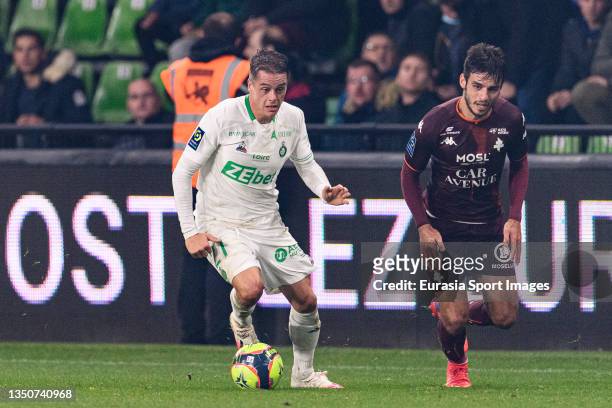 Romain Hamouma of Saint-Etienne is chased by Fabien Centonze of FC Metz during the Ligue 1 Uber Eats match between Metz and Saint-Etienne at Stade...