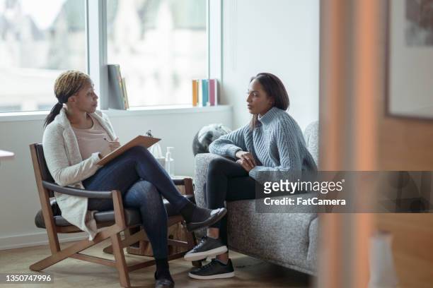 therapist meeting with a client - psychotherapy stock pictures, royalty-free photos & images