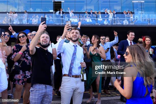 The crowd celebrate after watching the Melbourne Cup on the big screen during Sydney Racing at Royal Randwick Racecourse on November 02, 2021 in...