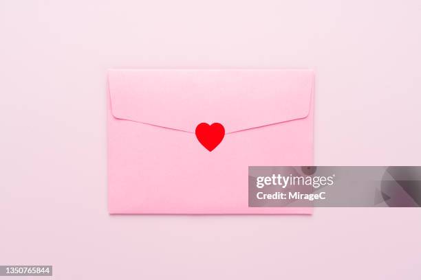 envelope sealed with red heart sticker - ラブレター ストックフォトと画像