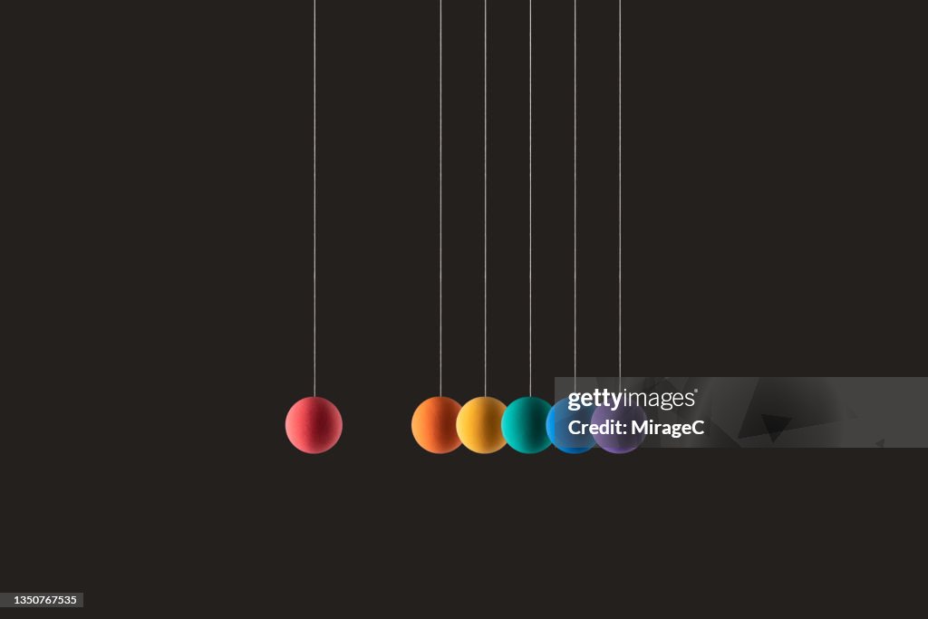 Rainbow Colored Spheres Hanging on Strings in a Row