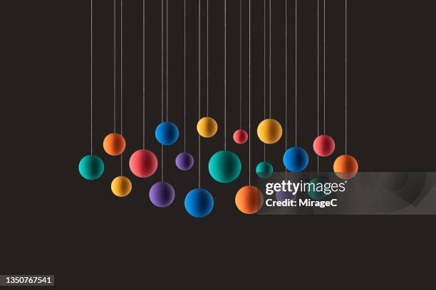 rainbow colored spheres hanging on strings - multi colored stock photos et images de collection