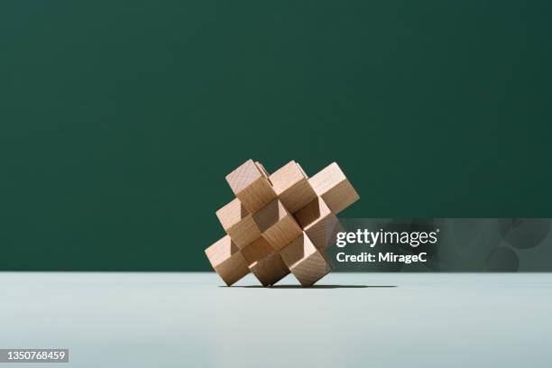 interlocked wood puzzle toys - rubiks cube stock-fotos und bilder