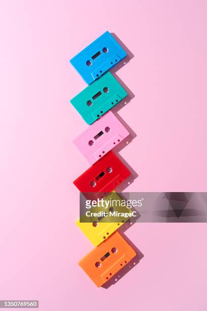 audio cassette tapes arranged on pink - pop music imagens e fotografias de stock