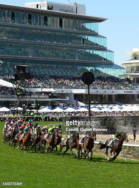 The field round the first bend in race 7, the Lexus Melbourne Cup during 2021 Melbourne Cup Day at Flemington Racecourse on November 02, 2021 in...