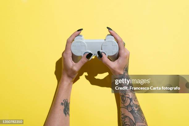 woman's hands holding joystick - gaming controller fotografías e imágenes de stock