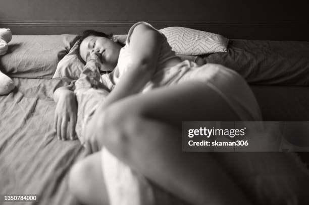 candid facial expression beautiful moment real people asian mother breastfeeding for daughter  on the bed black and white photography - family photo shoot stock pictures, royalty-free photos & images