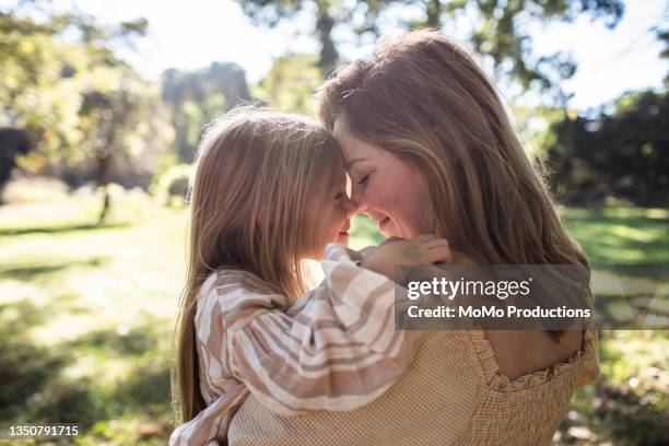 mother and daughter embracing in rural pasture - daughter ストックフォトと画像