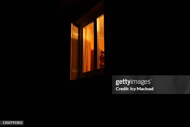 under the window - creepy house at night stock-fotos und bilder