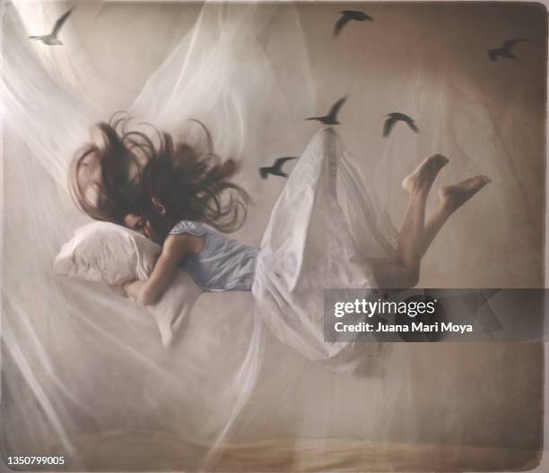 a sleeping woman floats in her room. - skirt blowing fotografías e imágenes de stock