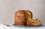 Italian sweet bread panettone on beige background. Copy space.