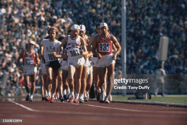 Paul Nihill of Great Britain , Volodymyr Holubnychy of the Soviet Union and, Larry Young of the United States lead the field around the stadium at...