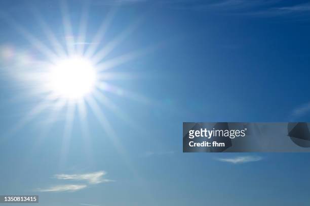 full bright sun in the blue sky - heat temperature stock pictures, royalty-free photos & images