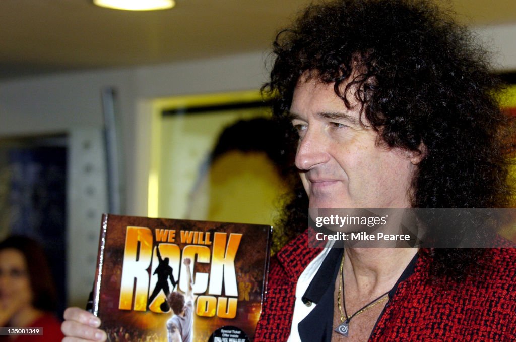 Brian May Signs "We Will Rock You" Show Book