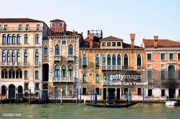 gondola along grand canal in venice - canale grande venedig stock-fotos und bilder