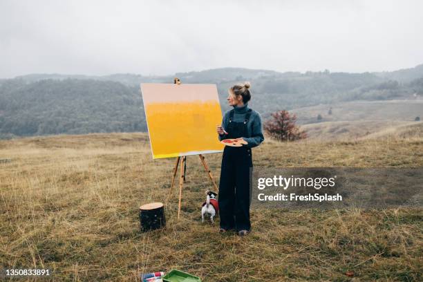 an anonymous woman artist painting landscape - artists with animals stock pictures, royalty-free photos & images