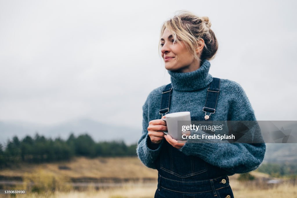 Beautiful Woman Drinking Tea in Nature