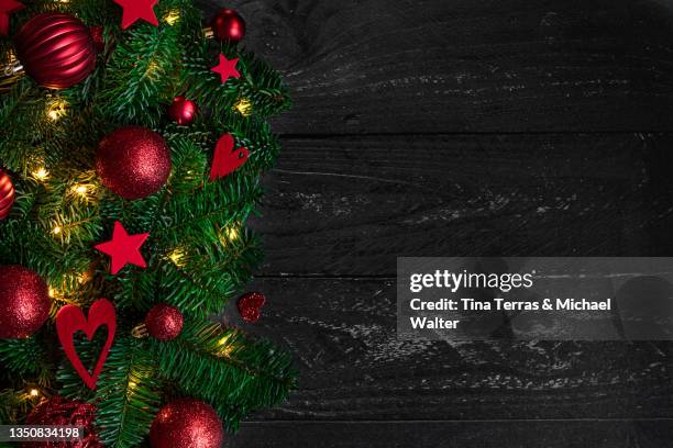 red christmas tree decorations on dark wooden table. copy space. flatlay. - christmas tree close up stock pictures, royalty-free photos & images
