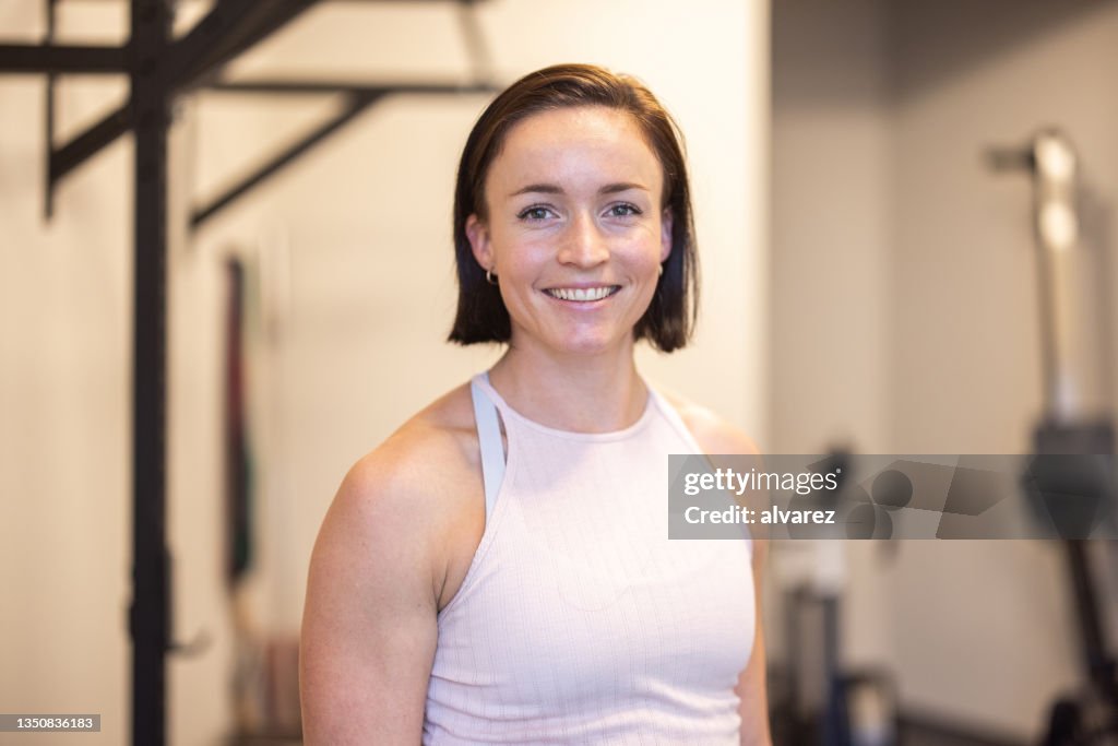 Portrait of fitness trainer smiling in gym