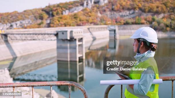 maintenance female engineer working in hydroelectric power station. renewable energy systems. - estação de tratamento de esgotos imagens e fotografias de stock