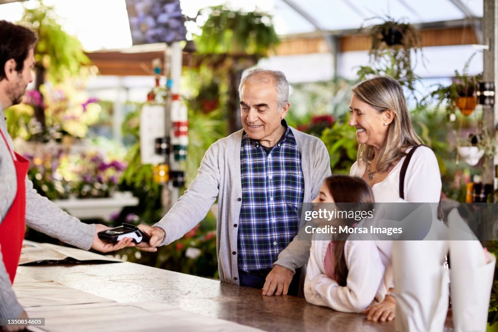 Senior man making payment with credit card