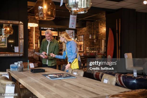 i love this wood table - luxury home dining table people lifestyle photography people stock pictures, royalty-free photos & images