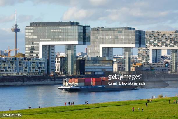 container ship passes the rheinauhafen near cologne - river rhine stock pictures, royalty-free photos & images