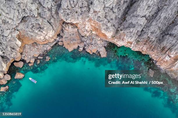 high angle view of rock formation in sea,khasab,oman - oman stock-fotos und bilder