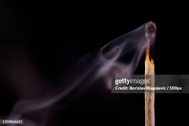 close-up of burning matchstick against black background,belgrade,serbia - matchstick stock pictures, royalty-free photos & images