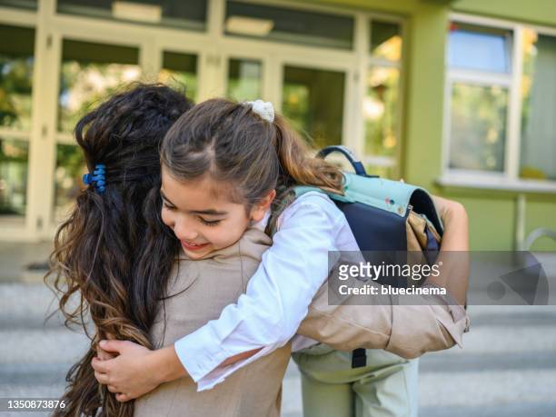 daughter hugging her mother after school - kids leaving school stock pictures, royalty-free photos & images