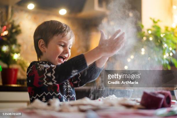 child cooking christmas cookies at the kitchen - flour christmas stock pictures, royalty-free photos & images