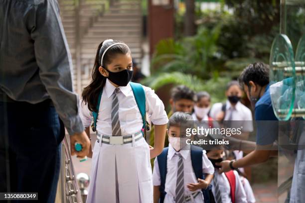 students getting temperature checked before entering school - coronavirus mask stock pictures, royalty-free photos & images