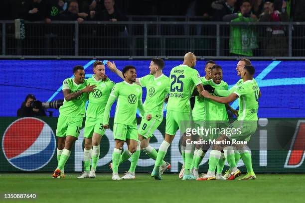 Ridle Baku of VfL Wolfsburg celebrates with teammates after scoring their team's first goal during the UEFA Champions League group G match between...