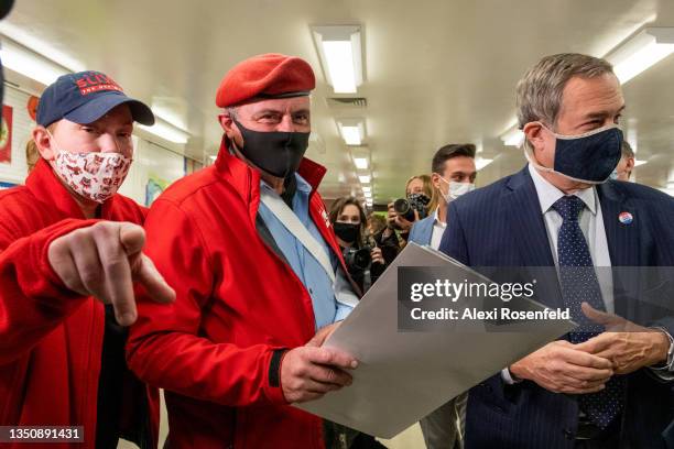 Nancy Regula points to a machine next to Republican mayoral candidate, Curtis Sliwa , holding his ballot after it gets stuck in a machine on the...