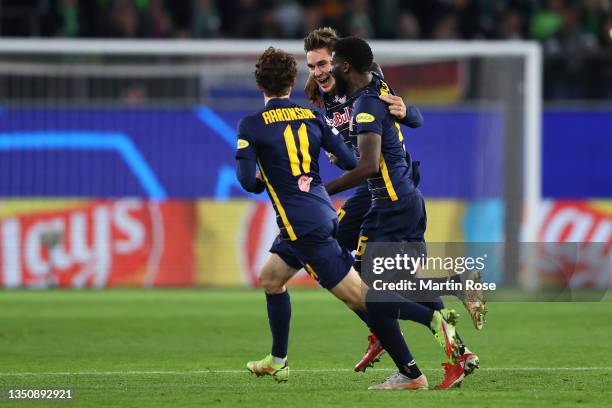 Maximilian Wober of RB Salzburg celebrates with teammates Brenden Aaronson andafter scoring their team's first goal during the UEFA Champions League...