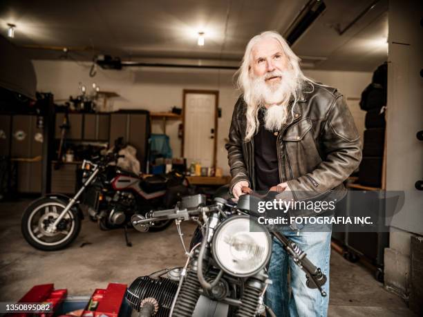 senior man working on his motorcycle - motorcycle workshop stock pictures, royalty-free photos & images