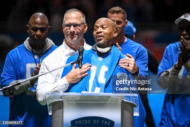 Chris Spielman, left, embraces William White, both former Detroit Lions players, during the Pride of the Lions celebration during halftime in the...