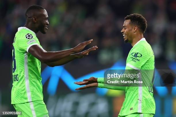 Lukas Nmecha of VfL Wolfsburg celebrates after scoring their team's second goal with teammate Josuha Guilavogui during the UEFA Champions League...