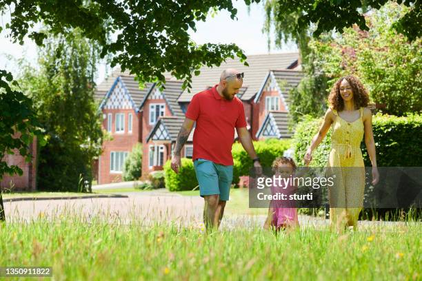 walking on the new estate - suburban family stock pictures, royalty-free photos & images