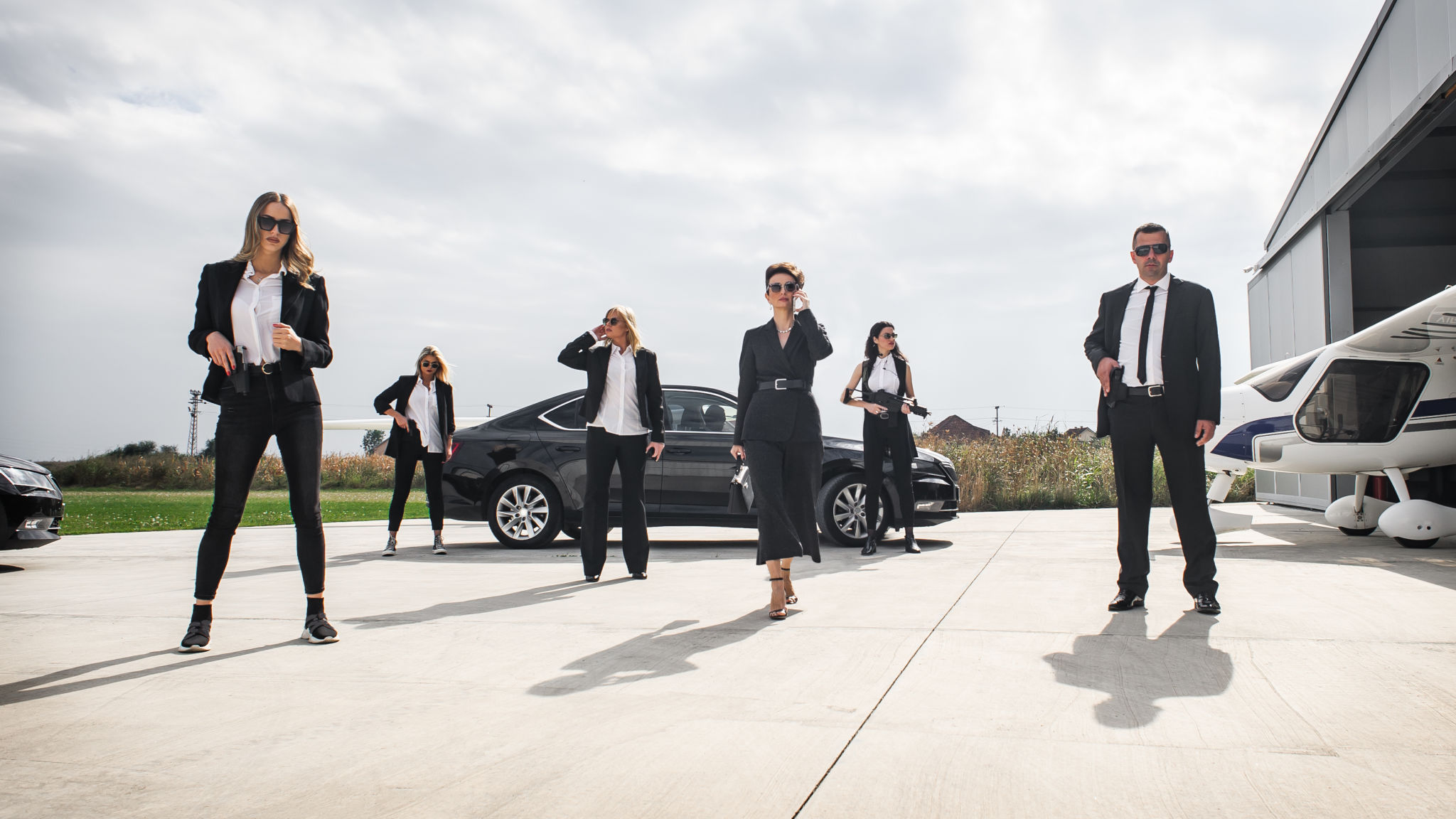 Female male security bodyguards team protect VIP celebrity public person Female male security bodyguards team protect VIP celebrity public person