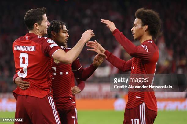 Serge Gnabry of FC Bayern Muenchen celebrates with teammates Robert Lewandowski and Leroy Sane after scoring their team's second goal during the UEFA...
