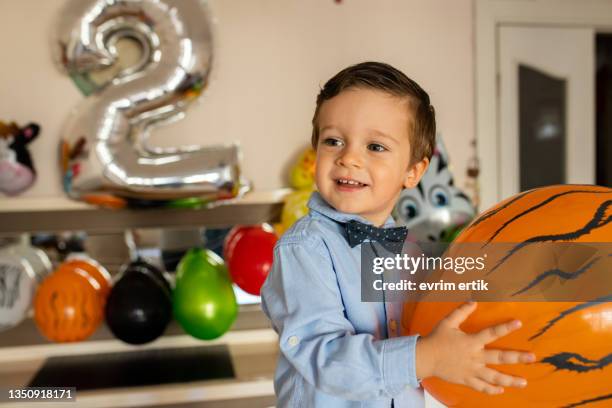 two year old boy holding birthday balloon - turkish culture stock pictures, royalty-free photos & images