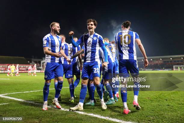 Tom Bayliss of Wigan Athletic celebrates their side's third goal scored by Curtis Tilt during the Sky Bet League One match between Fleetwood Town and...