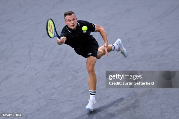 Marton Fucsovics of Hungary plays a forehand during his singles match against Novak Djokovic of Serbia during day two of the Rolex Paris Masters at...