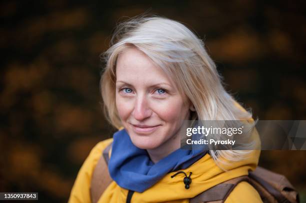 portrait of a blond woman outdoors - bright blue eyes stock pictures, royalty-free photos & images