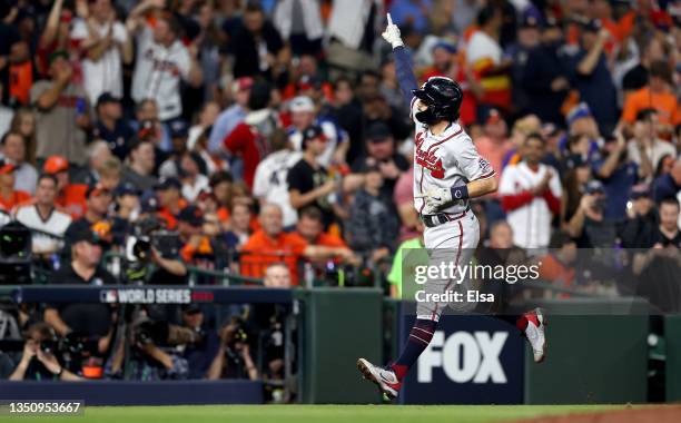 Dansby Swanson of the Atlanta Braves celebrates as he rounds the bases after hitting a two run home run against the Houston Astros during the fifth...